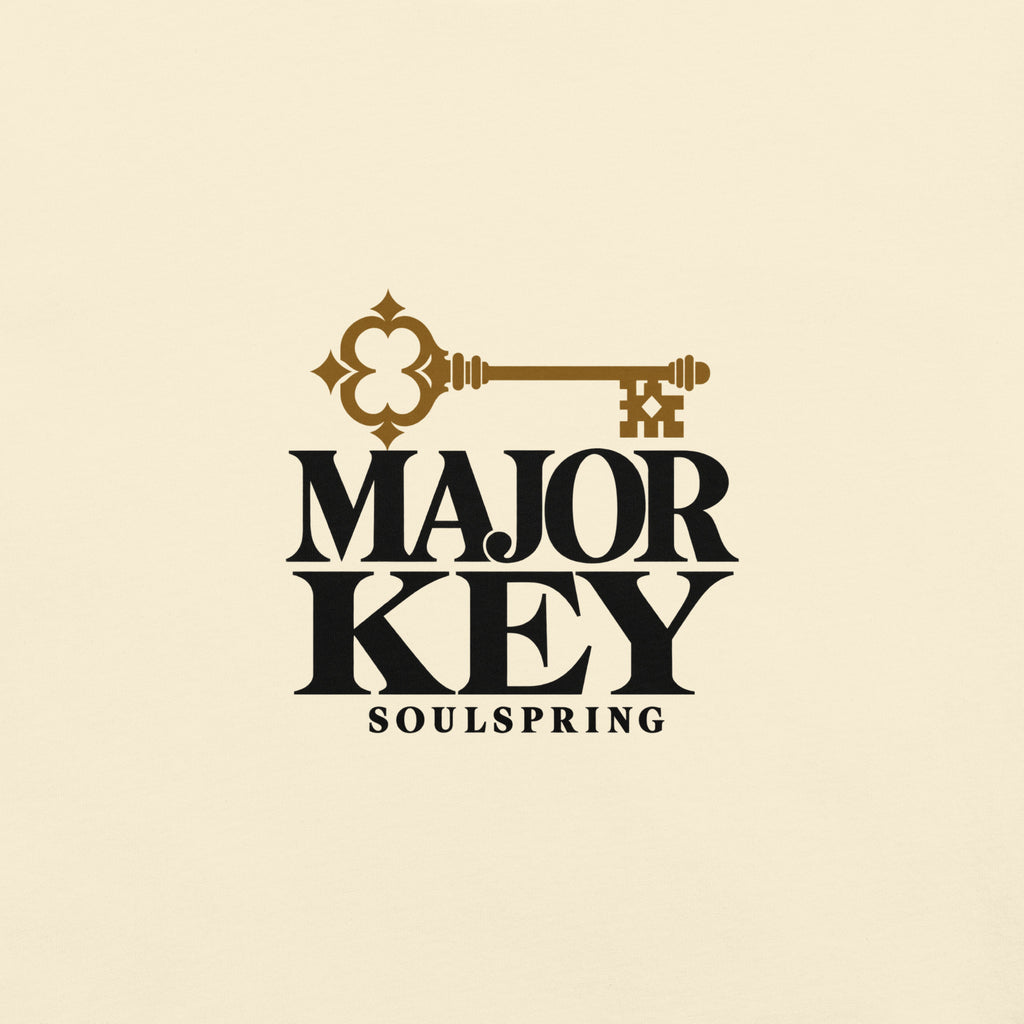 Close-up mockup of the Major Key lettering and ochre key print on ivory cotton